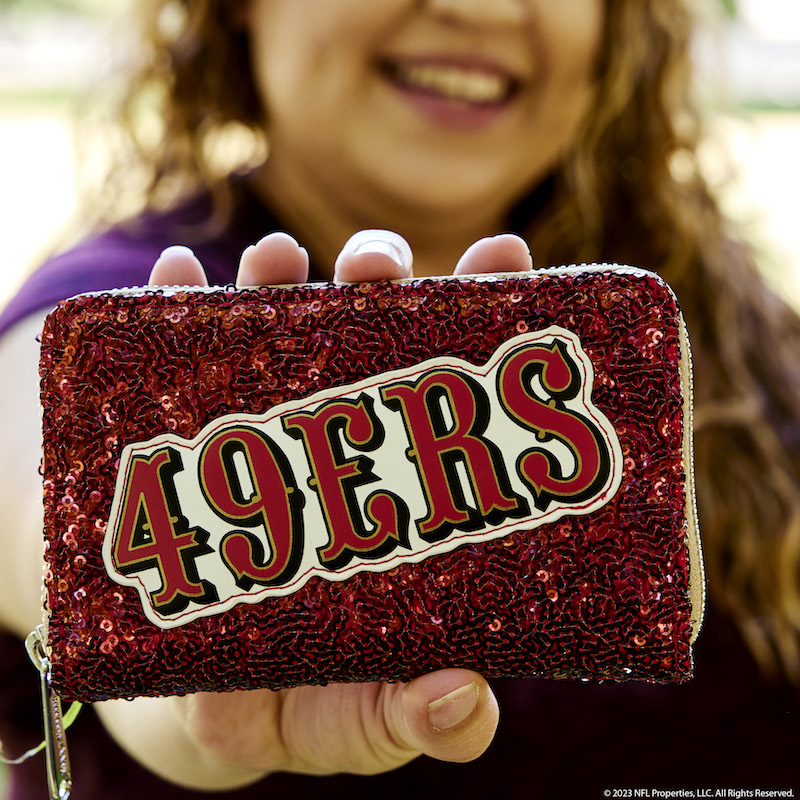 Image of woman holding out the San Francisco 49ers Sequin Wallet toward the camera